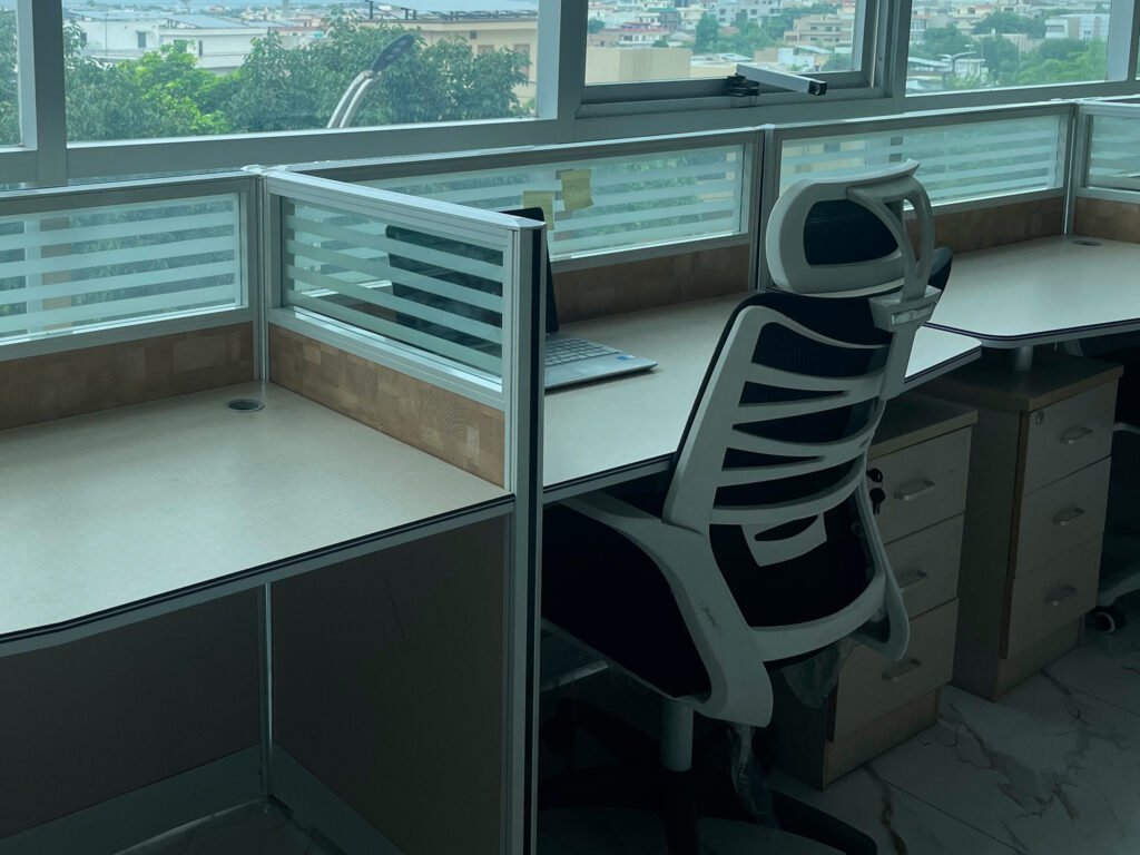 A dedicated chair with amazing window view showing the whole islamabad city with glowing lights and rainy day outside.